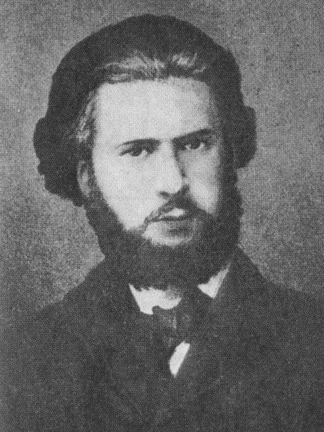 Photographie : portrait d’Eugène Varlin jeune, barbe et cheveux bruns, en veston sombre